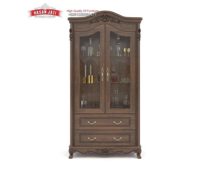 Katalog resmi tampak depan lemari pajangan kristal seri Cordelia dari kayu jati dengan ambalan kaca dan 2 laci bawah produk Hasan Jati Furniture.