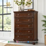 Lemari kabinet pakaian chest dengan 5 tingkatan laci tinggi dan pot bunga hias di atasnya tipe Porter produk Hasan Jati Furniture.