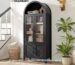 Lemari pajangan jati hitam 4 pintu kaca dengan desain melengkung modern di ruang tamu.