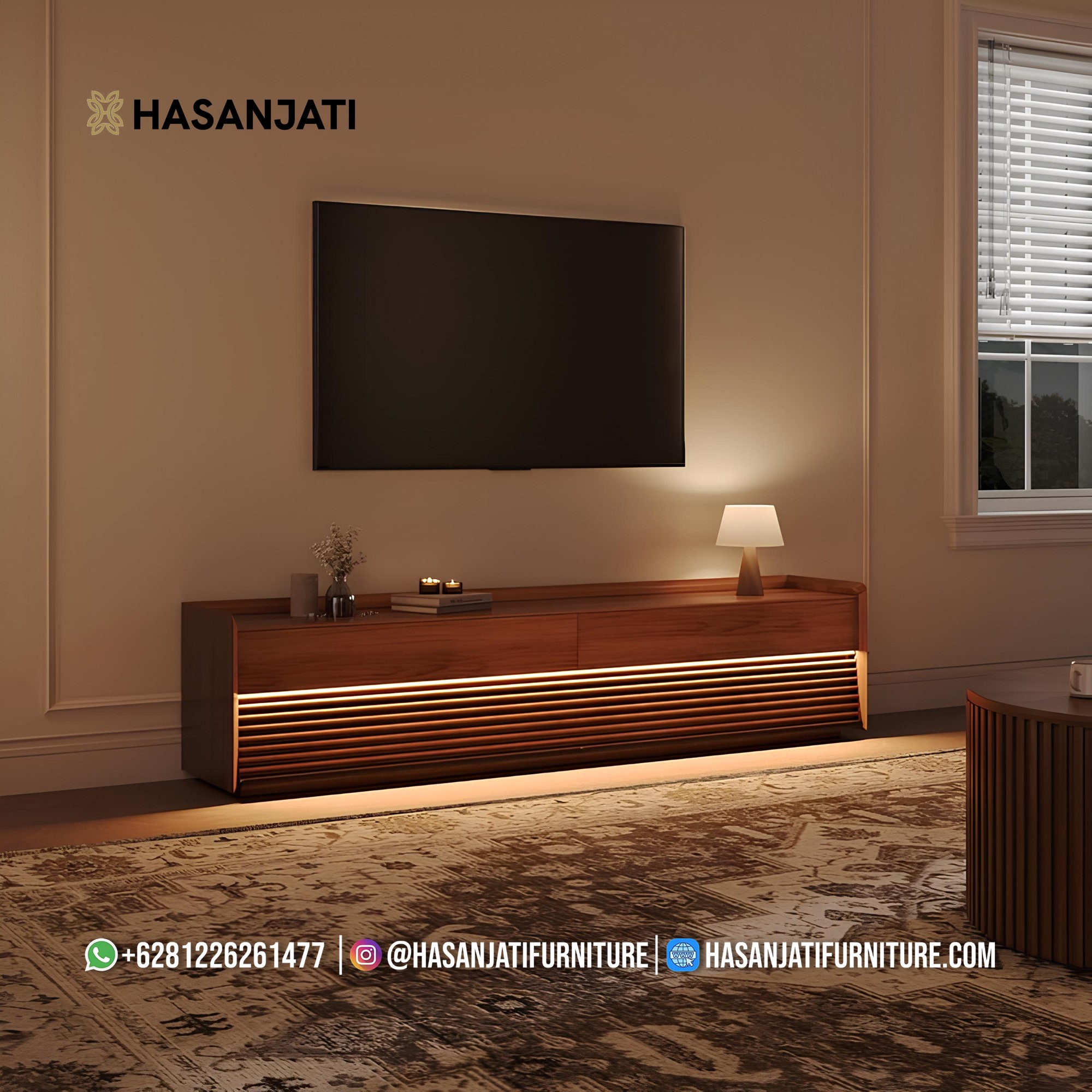 Meja TV minimalis kayu jati di ruang tamu modern dengan pencahayaan hangat dan dekorasi sederhana.