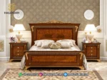Tempat tidur mewah jati seri Aida dengan lampu tidur menyala produk Hasan Jati Furniture.